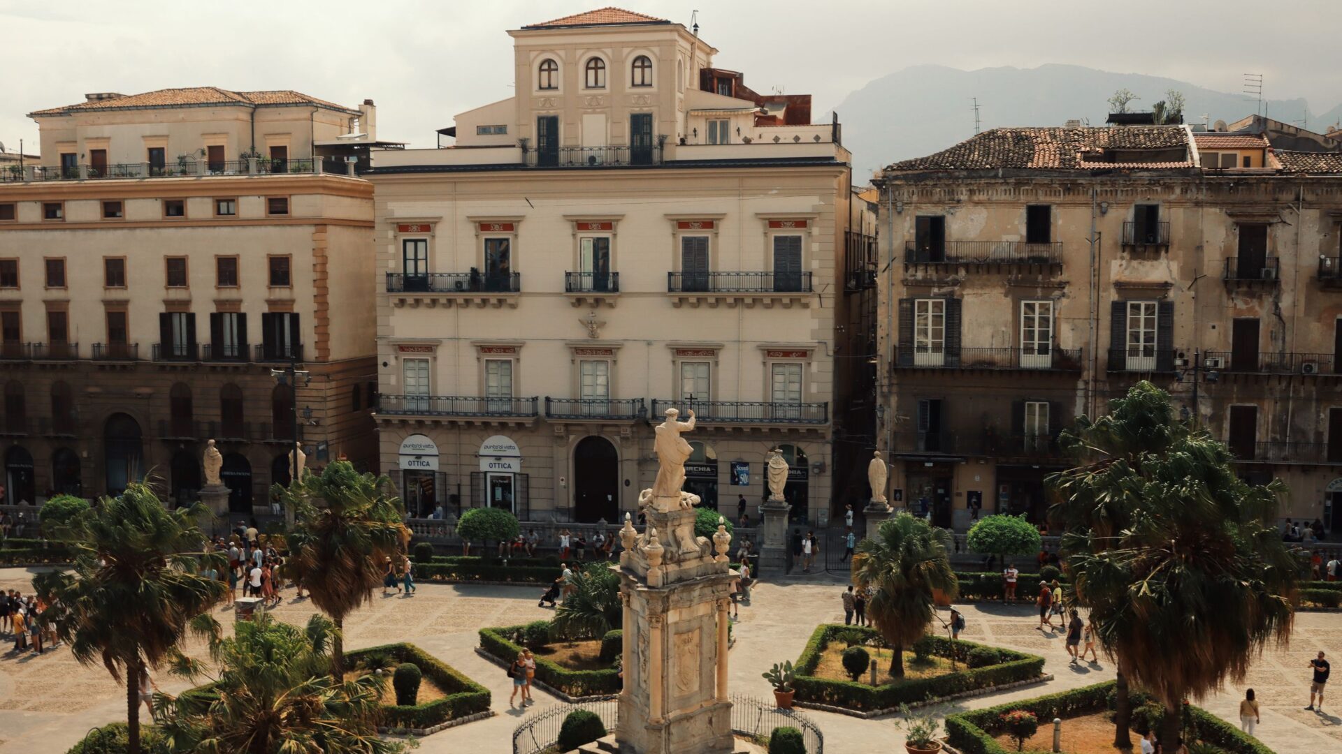 Aerial shot of a historic piazza in Palermo, Italy with landmarks and urban architecture.